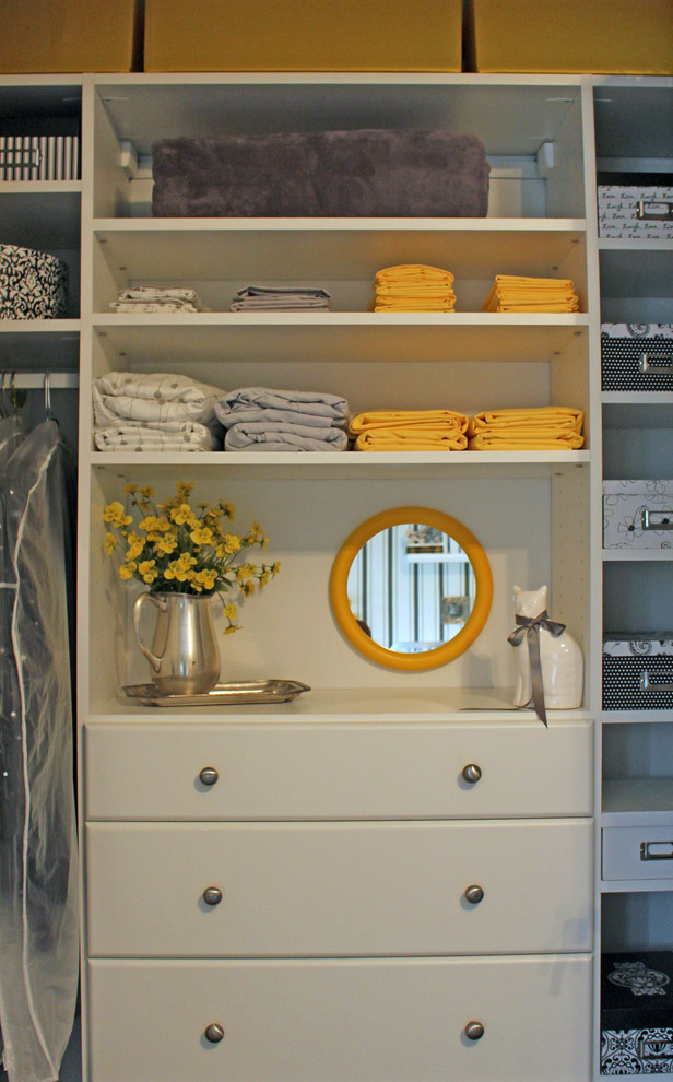 Design ideas for a small traditional gender neutral standard wardrobe in Austin with white cabinets.