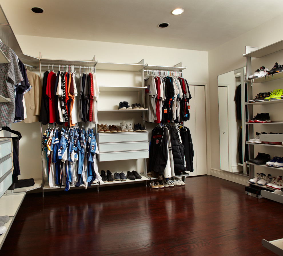 Large contemporary walk-in wardrobe for men in Miami with open cabinets, medium wood cabinets and dark hardwood flooring.