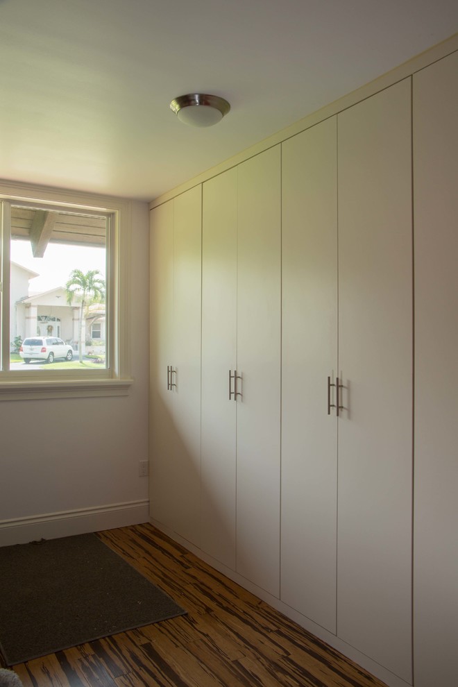 Design ideas for a medium sized contemporary gender neutral standard wardrobe in Miami with open cabinets, white cabinets and bamboo flooring.