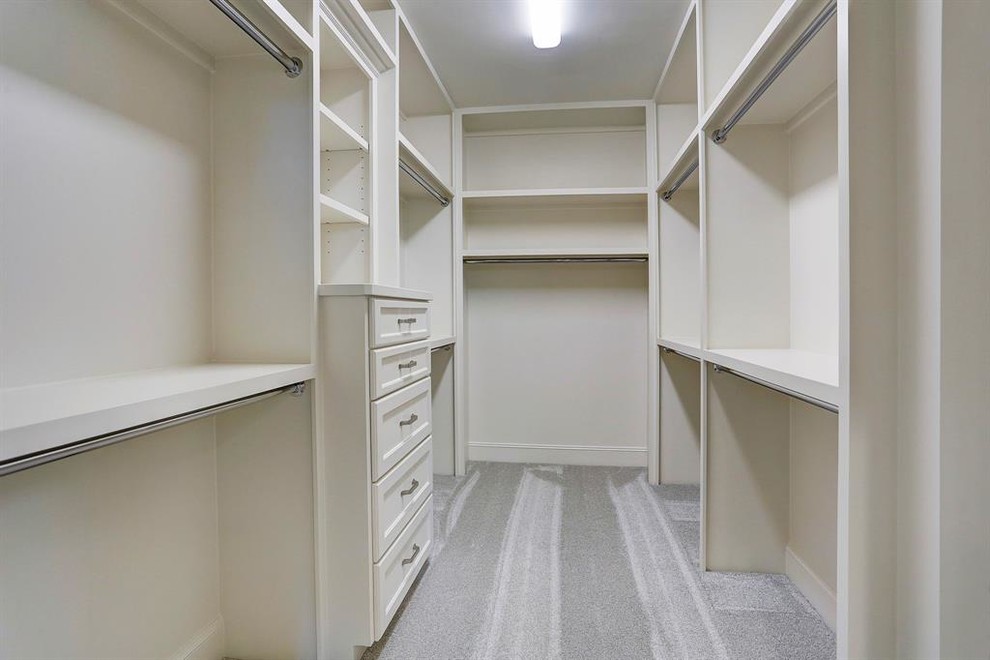 Photo of a large contemporary walk-in wardrobe in Houston with shaker cabinets, white cabinets, carpet and grey floors.