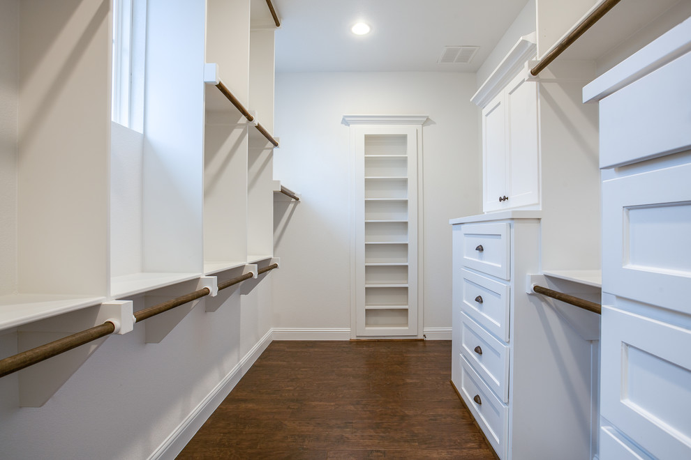 Inspiration for a large cottage gender-neutral medium tone wood floor and brown floor walk-in closet remodel in Dallas with shaker cabinets and white cabinets