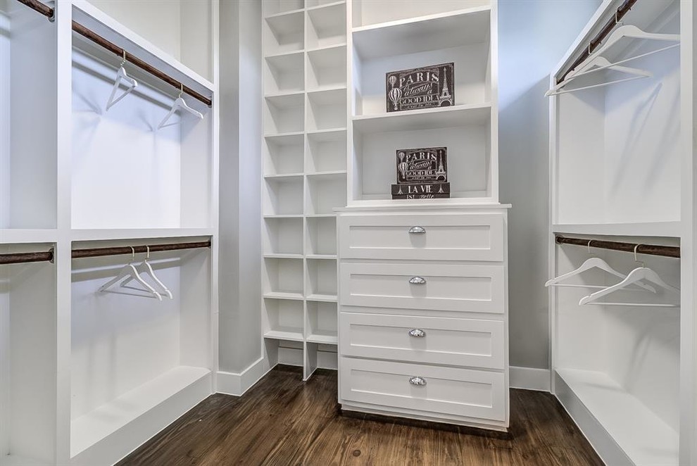 This is an example of a medium sized classic dressing room for men in Houston with shaker cabinets, white cabinets, dark hardwood flooring and brown floors.