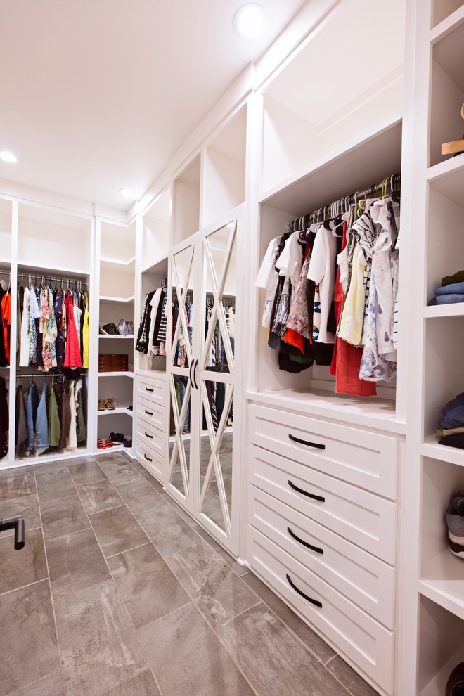 Example of a transitional porcelain tile and gray floor walk-in closet design with shaker cabinets and white cabinets