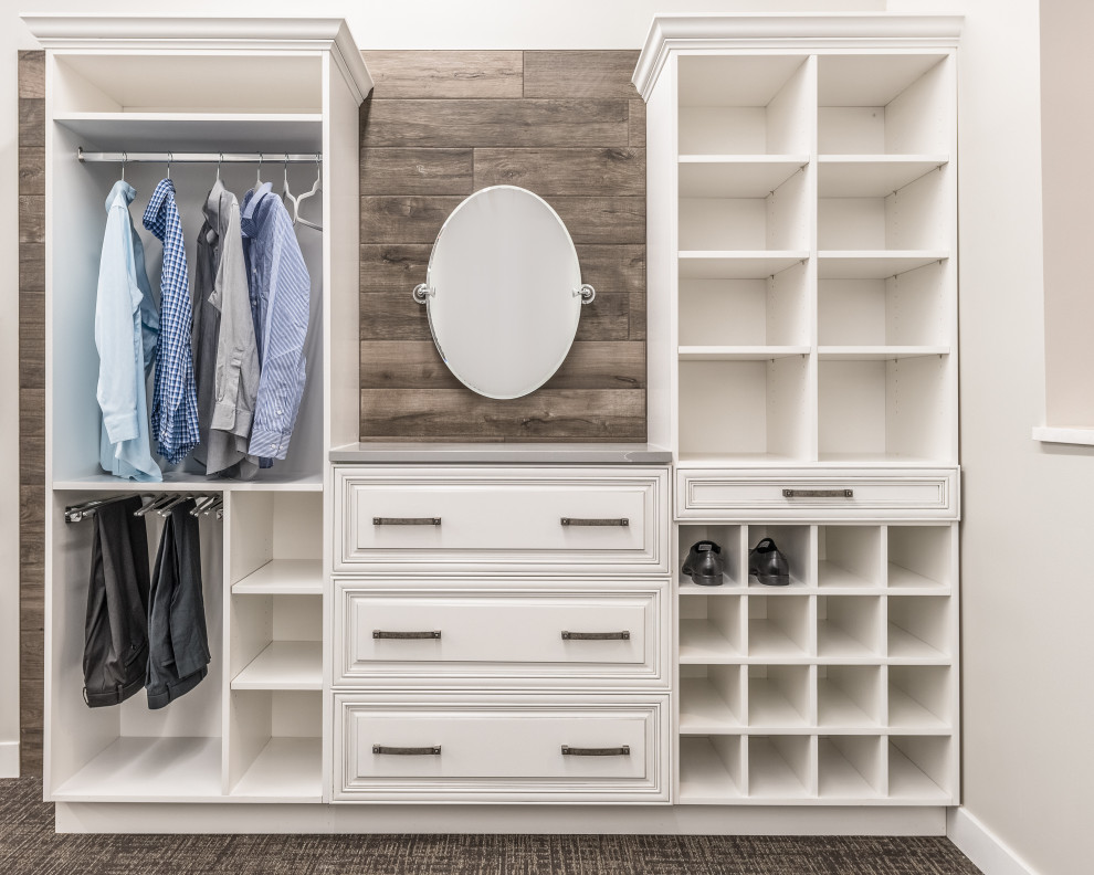 Design ideas for a small traditional gender neutral dressing room in Other with raised-panel cabinets, beige cabinets, carpet and multi-coloured floors.