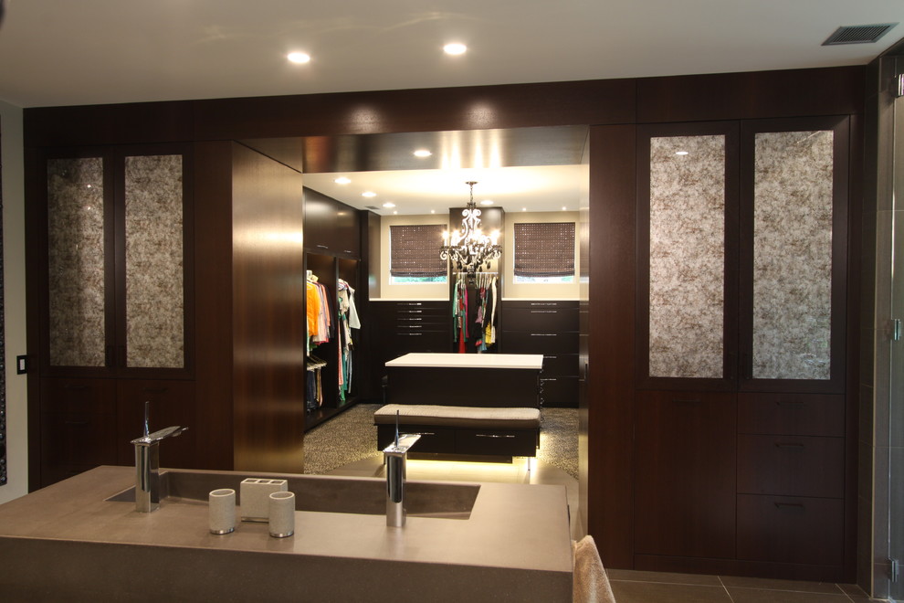 Photo of a large contemporary walk-in wardrobe in Grand Rapids with flat-panel cabinets and brown cabinets.