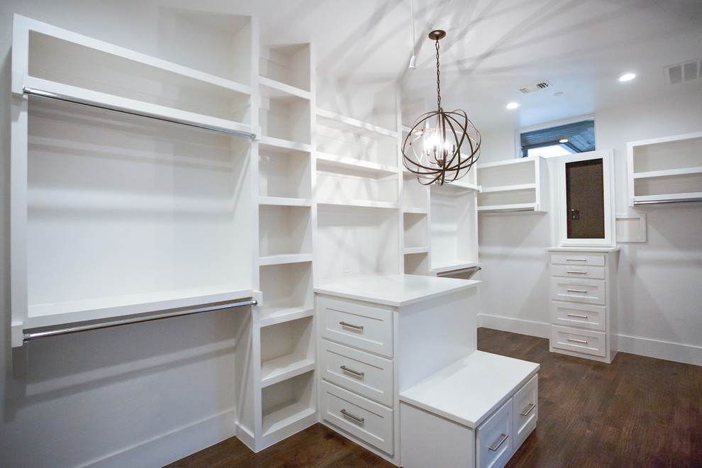 Example of a large transitional gender-neutral medium tone wood floor and brown floor dressing room design in Dallas with shaker cabinets and white cabinets