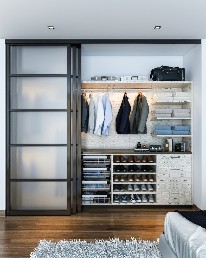 Example of a mid-sized minimalist men's reach-in closet design in Los Angeles