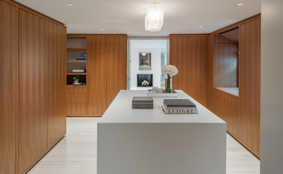 Inspiration for a contemporary gender-neutral beige floor dressing room remodel in Boston with flat-panel cabinets and medium tone wood cabinets