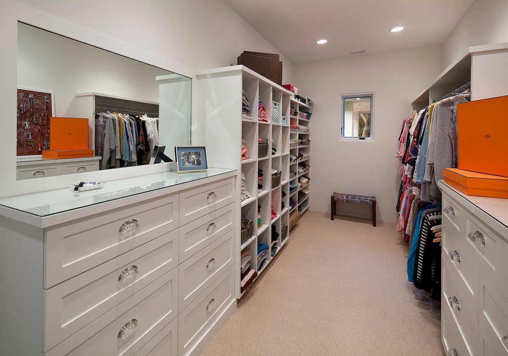 Large contemporary gender neutral walk-in wardrobe in Santa Barbara with shaker cabinets, white cabinets and carpet.