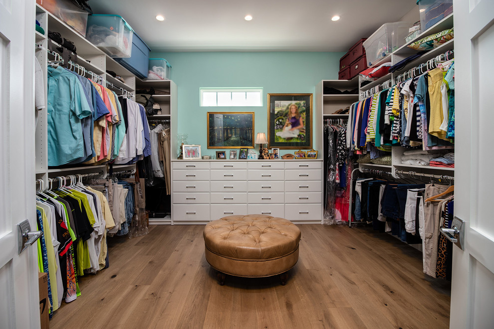 Medium sized traditional gender neutral walk-in wardrobe in Other with shaker cabinets, white cabinets, medium hardwood flooring and brown floors.