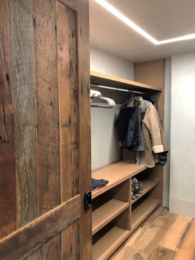 Bild på ett mellanstort funkis walk-in-closet för könsneutrala, med öppna hyllor, skåp i ljust trä, ljust trägolv och brunt golv