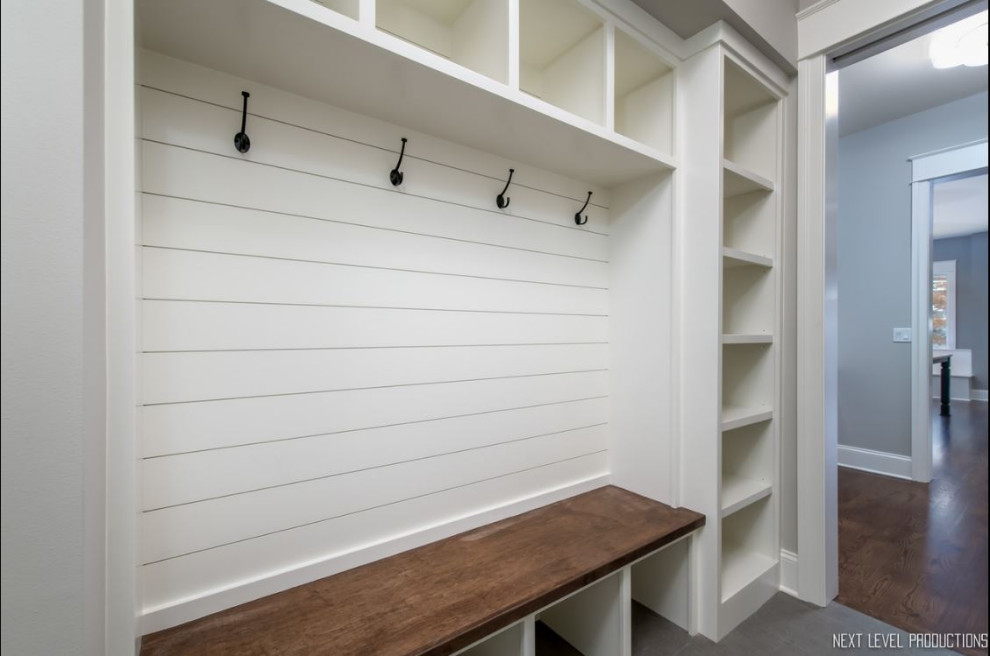 Medium sized country gender neutral built-in wardrobe in Chicago with open cabinets, white cabinets, ceramic flooring and grey floors.