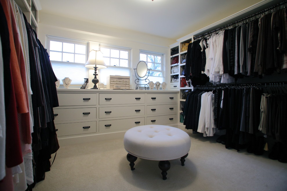 Large elegant women's carpeted walk-in closet photo in Portland with flat-panel cabinets and white cabinets