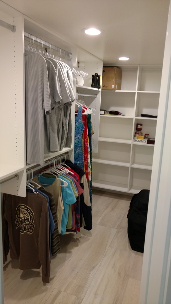 Medium sized traditional gender neutral walk-in wardrobe in Tampa with open cabinets, white cabinets and porcelain flooring.