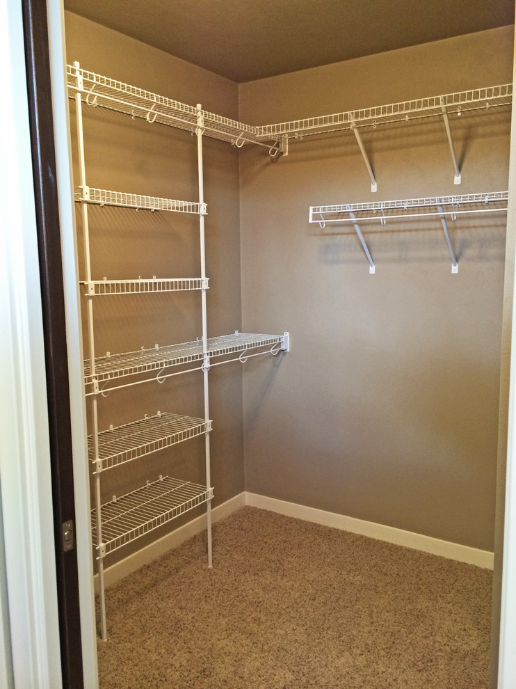 Inspiration for a mid-sized craftsman gender-neutral carpeted walk-in closet remodel in Milwaukee
