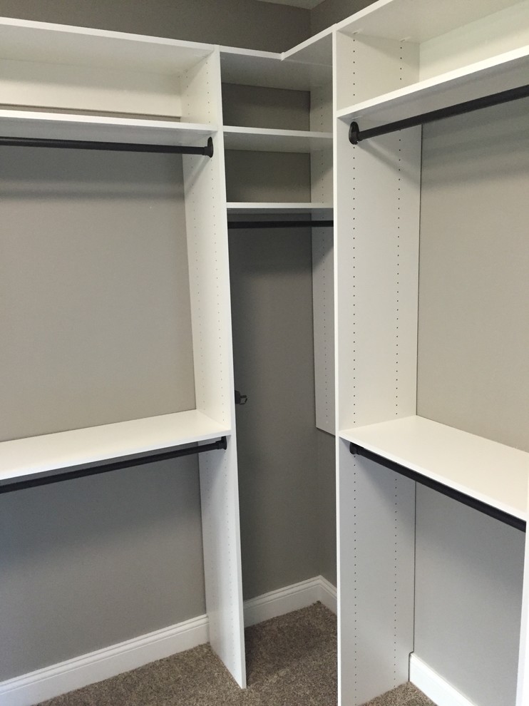 Design ideas for a small contemporary walk-in wardrobe in Other with flat-panel cabinets and white cabinets.