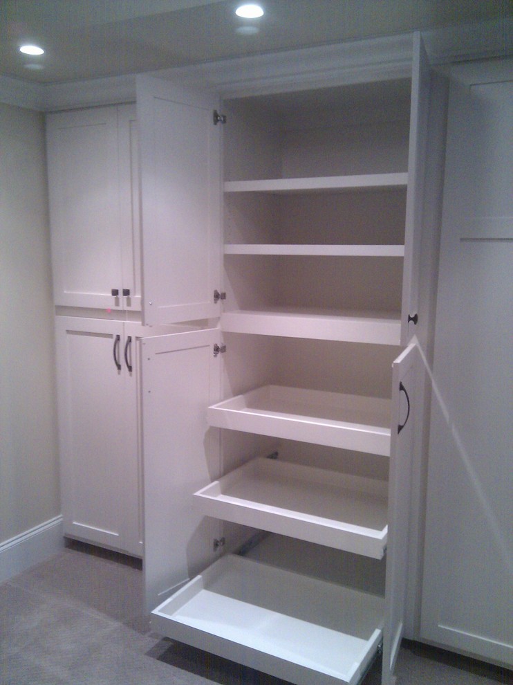 Classic gender neutral dressing room in Atlanta with open cabinets, white cabinets and carpet.