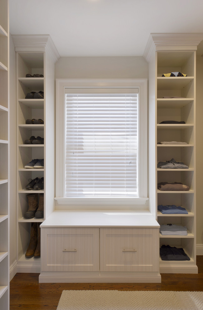Large trendy gender-neutral dark wood floor walk-in closet photo in New York with shaker cabinets and white cabinets