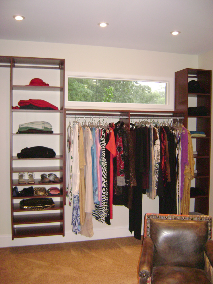 Mid-sized elegant gender-neutral carpeted walk-in closet photo in Richmond with open cabinets and medium tone wood cabinets