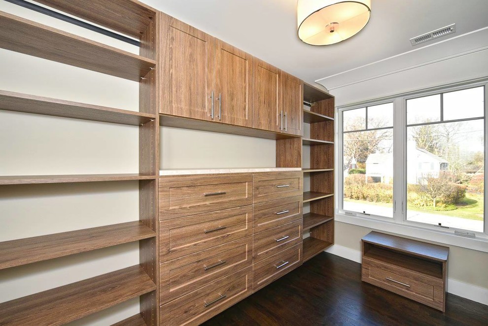 Inspiration for a mid-sized craftsman gender-neutral dark wood floor walk-in closet remodel in Chicago with open cabinets and medium tone wood cabinets