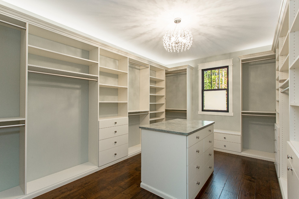 Photo of a medium sized classic gender neutral walk-in wardrobe in Richmond with flat-panel cabinets, white cabinets, dark hardwood flooring and brown floors.
