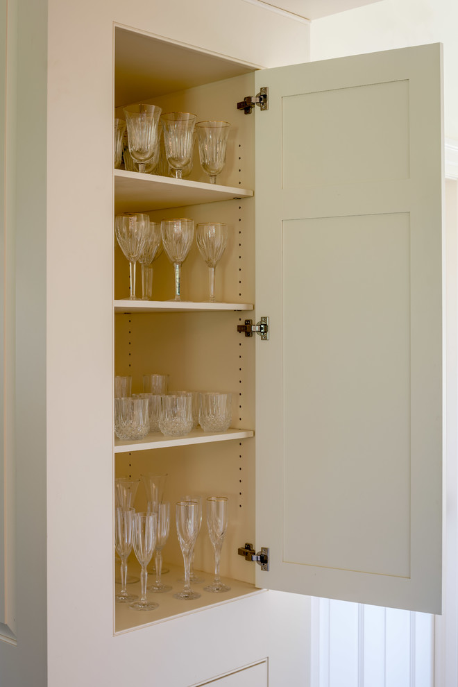 Small classic standard wardrobe in Philadelphia with raised-panel cabinets and white cabinets.