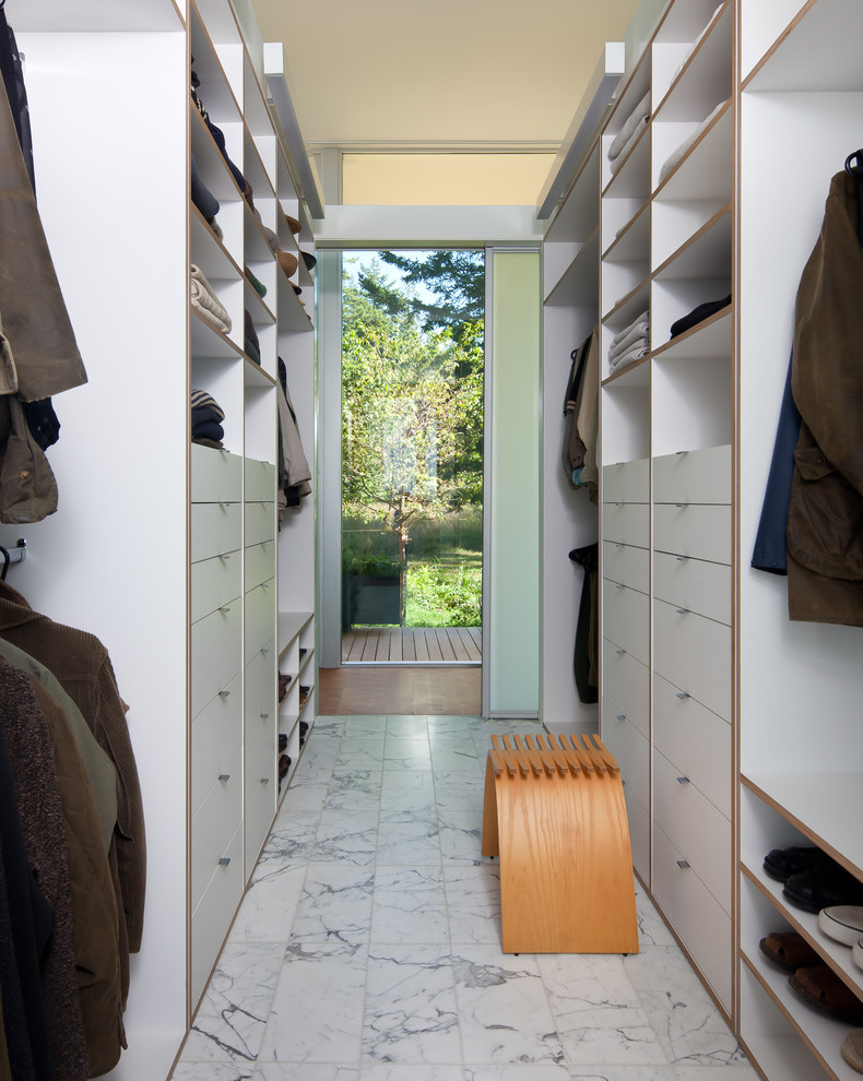 Modern walk-in wardrobe for men in Seattle with open cabinets and white cabinets.