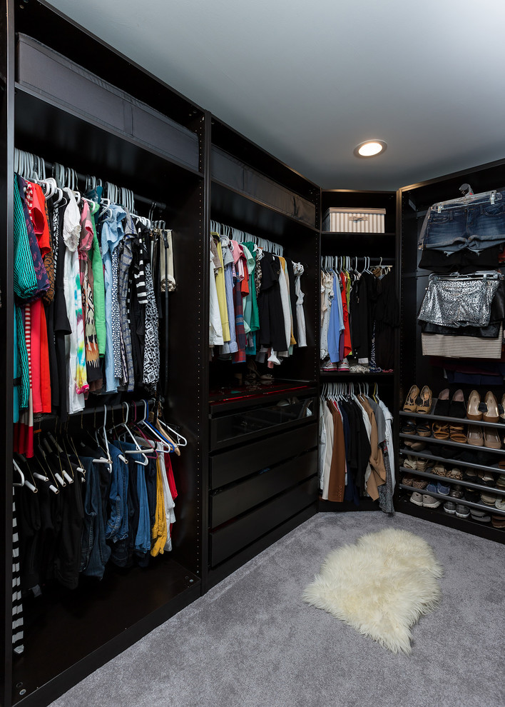 Photo of a medium sized contemporary gender neutral walk-in wardrobe in Miami with open cabinets, dark wood cabinets and carpet.