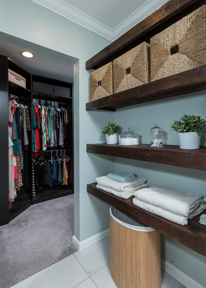 Design ideas for a small contemporary gender neutral walk-in wardrobe in Miami with open cabinets, dark wood cabinets and carpet.
