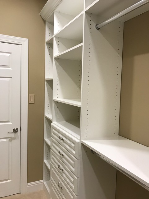 Inspiration for a large classic walk-in wardrobe for women in Other with raised-panel cabinets, white cabinets and carpet.