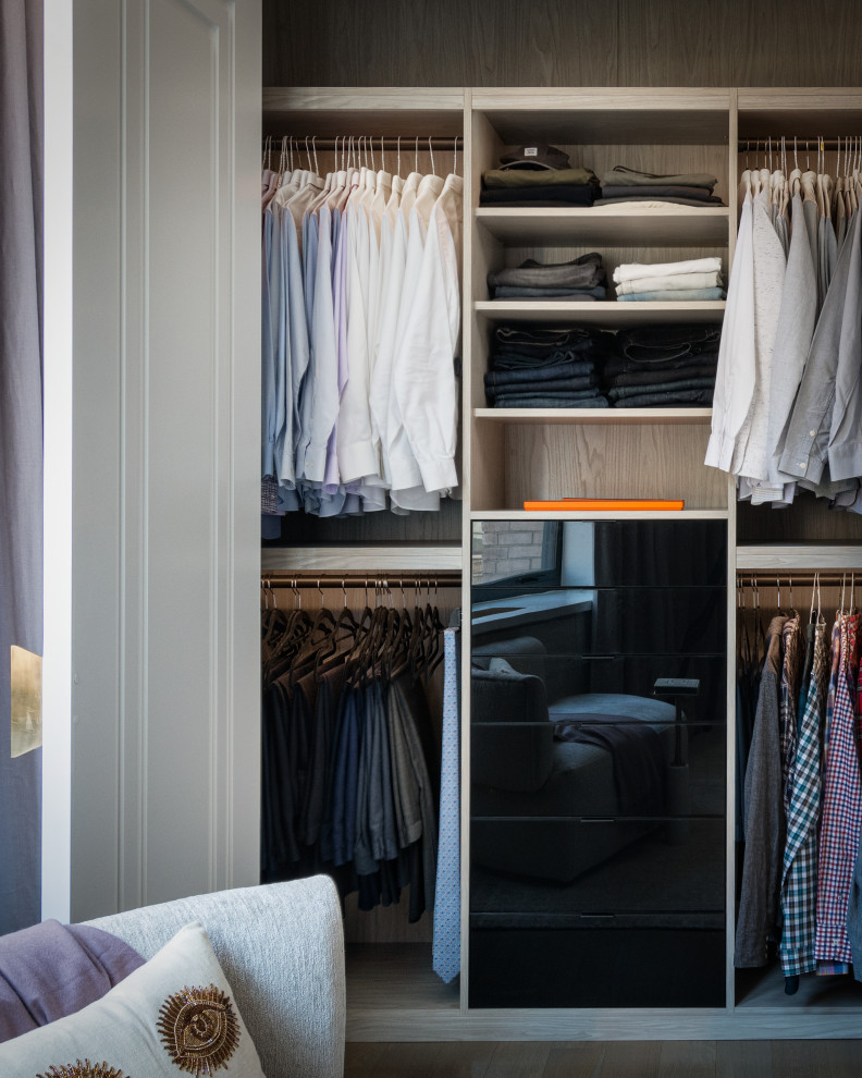 Example of a mid-sized men's walk-in closet design in New York with open cabinets and gray cabinets