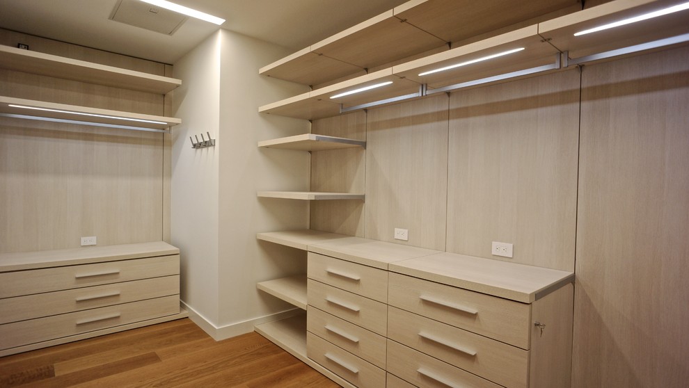 Inspiration for a large modern gender-neutral medium tone wood floor walk-in closet remodel in Miami with flat-panel cabinets and light wood cabinets