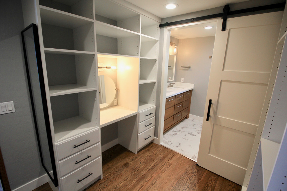 Walk-in closet - mid-sized contemporary gender-neutral medium tone wood floor and brown floor walk-in closet idea in San Francisco with flat-panel cabinets and medium tone wood cabinets