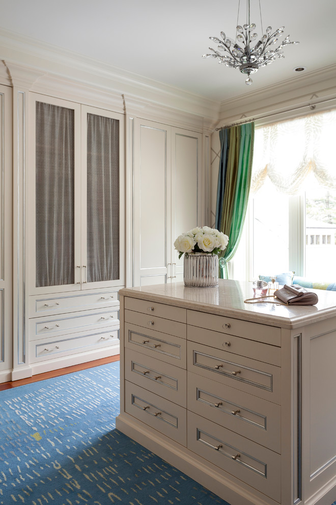 This is an example of a classic dressing room in Toronto with recessed-panel cabinets and beige cabinets.