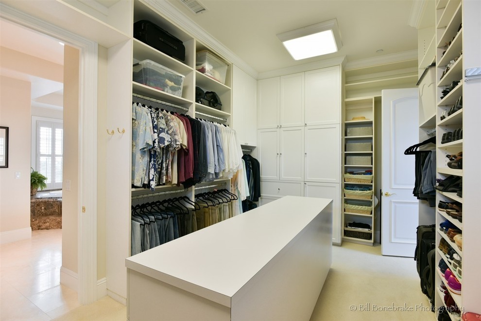 Inspiration for a large classic gender neutral walk-in wardrobe in Austin with recessed-panel cabinets, white cabinets and carpet.