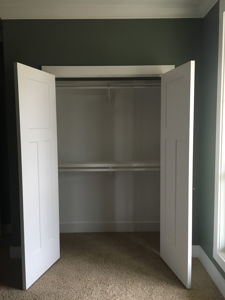 Reach-in closet - mid-sized traditional gender-neutral carpeted reach-in closet idea in New Orleans with white cabinets