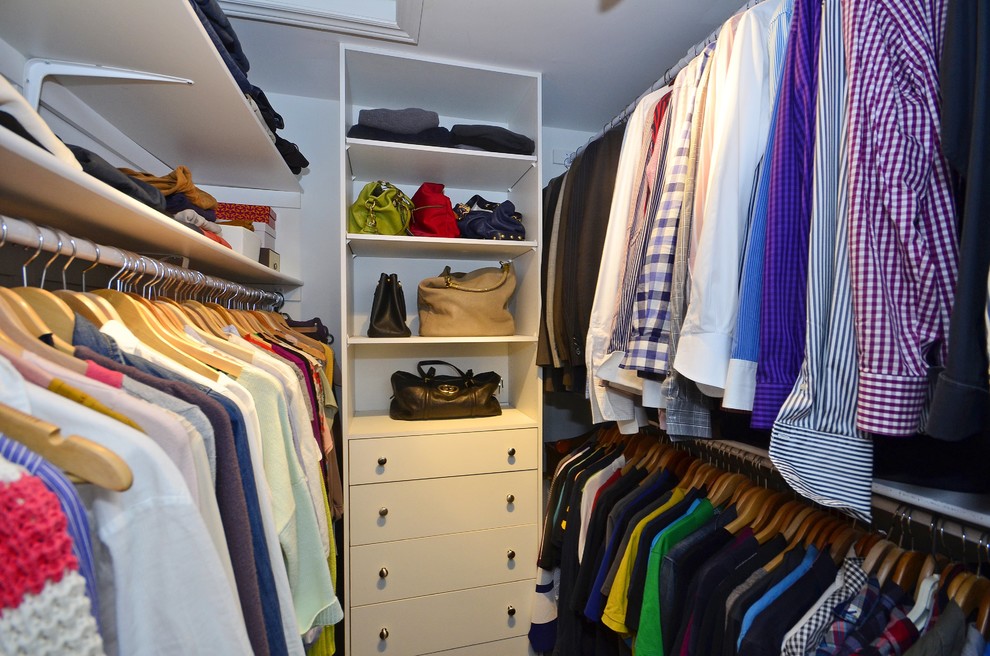 This is an example of a large traditional gender neutral walk-in wardrobe in Toronto with flat-panel cabinets and white cabinets.