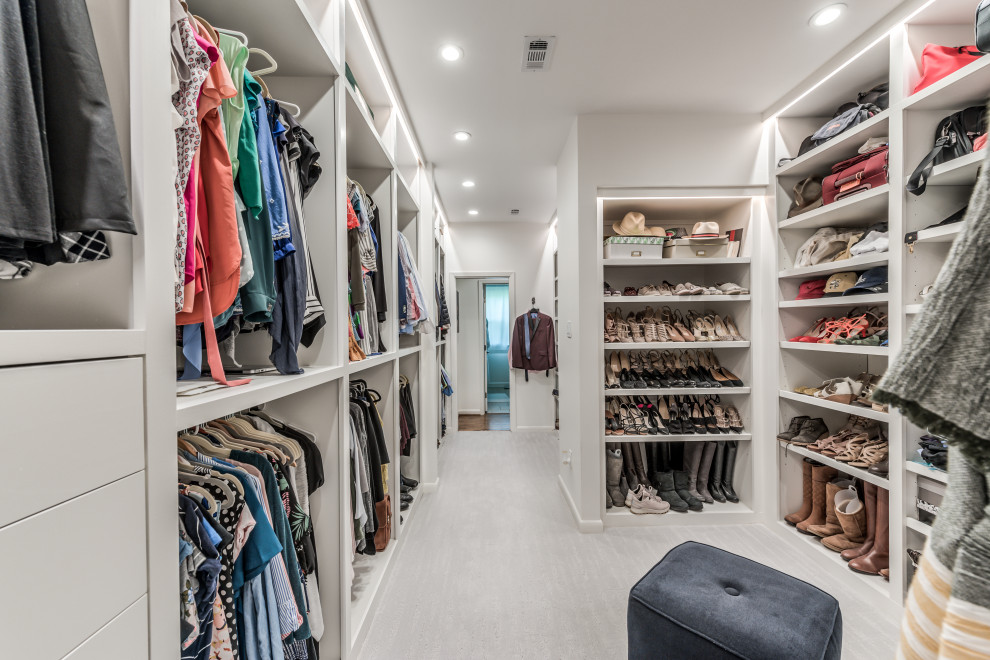 Inspiration for a large french country gender-neutral carpeted and white floor built-in closet remodel in Houston with white cabinets