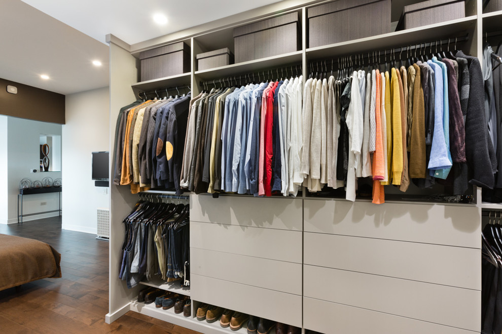 Design ideas for a small contemporary gender neutral wardrobe in Chicago with flat-panel cabinets, grey cabinets and medium hardwood flooring.