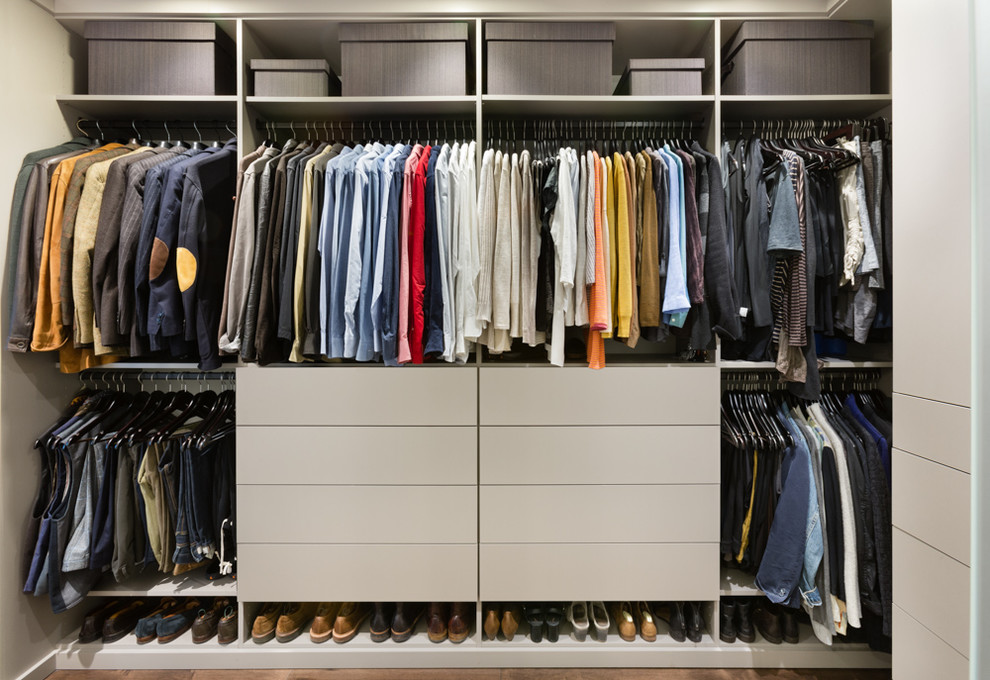 Example of a small trendy gender-neutral medium tone wood floor closet design in Chicago with flat-panel cabinets and gray cabinets