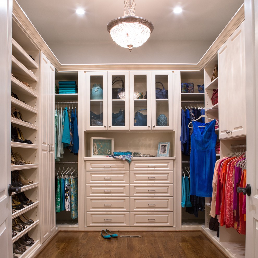Inspiration for a contemporary medium tone wood floor closet remodel in Richmond with white cabinets