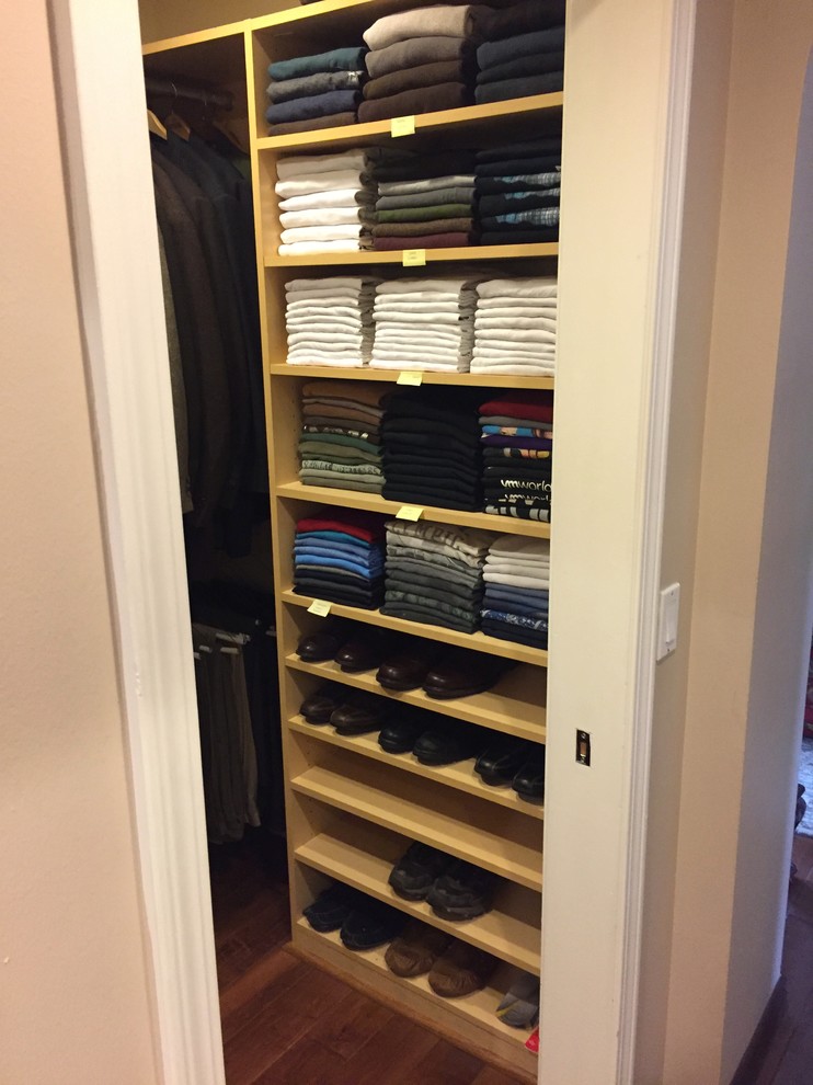 This is an example of a medium sized classic walk-in wardrobe for men in Los Angeles with open cabinets, light wood cabinets, dark hardwood flooring and brown floors.