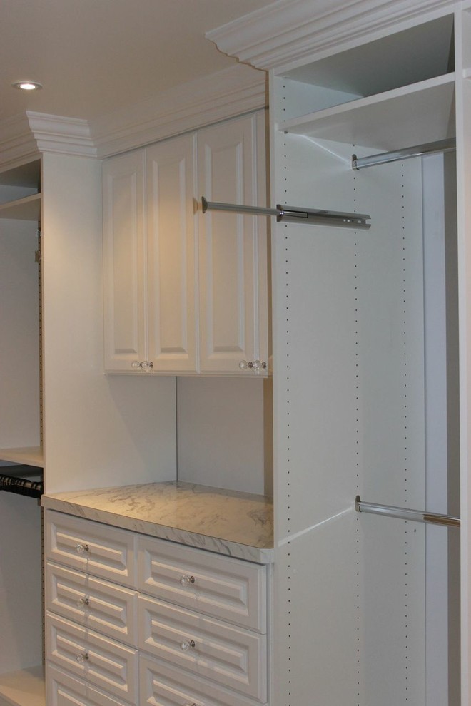 Walk-in closet - large traditional walk-in closet idea in Other with white cabinets and raised-panel cabinets