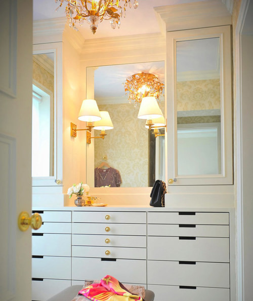 This is an example of a medium sized classic walk-in wardrobe for women in San Diego with flat-panel cabinets and white cabinets.