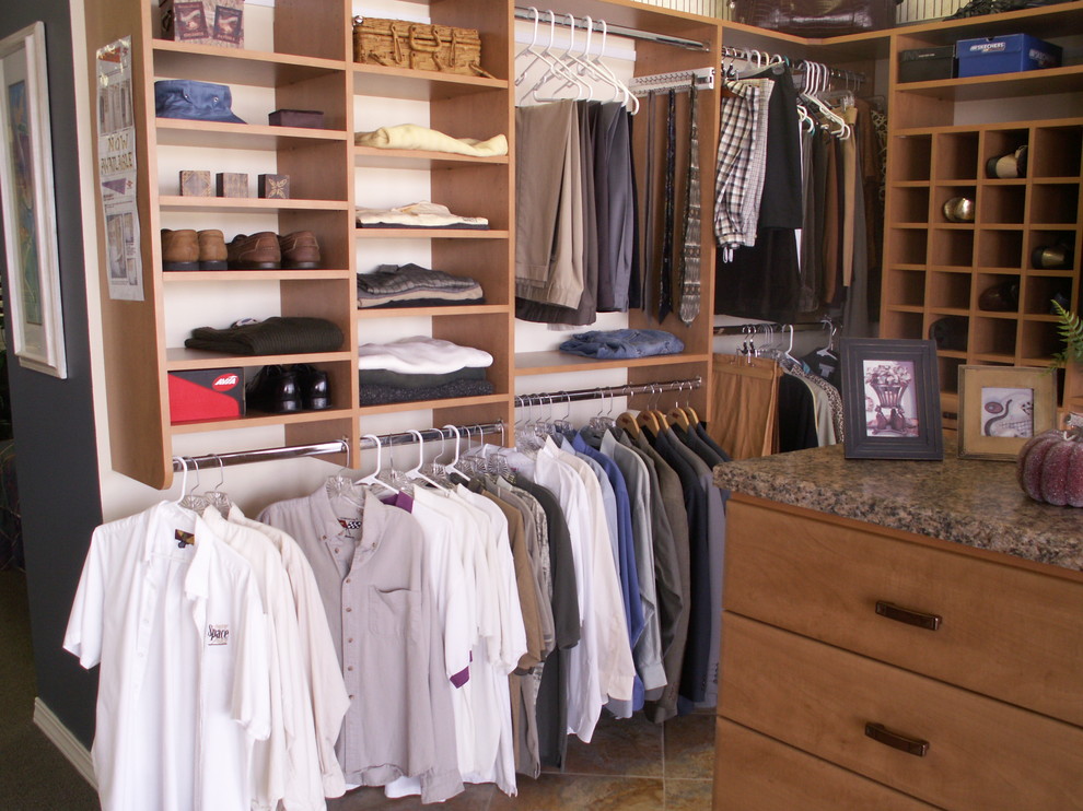Inspiration for a large contemporary gender neutral walk-in wardrobe in Tampa with flat-panel cabinets, medium wood cabinets and ceramic flooring.