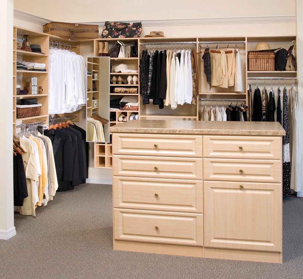 Inspiration for a large contemporary gender neutral walk-in wardrobe in Tampa with raised-panel cabinets, light wood cabinets and carpet.