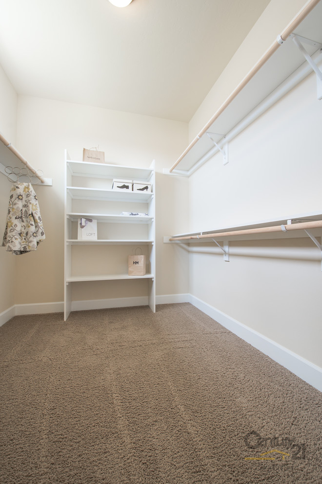 Inspiration for a large rustic carpeted walk-in closet remodel in Seattle with shaker cabinets and white cabinets