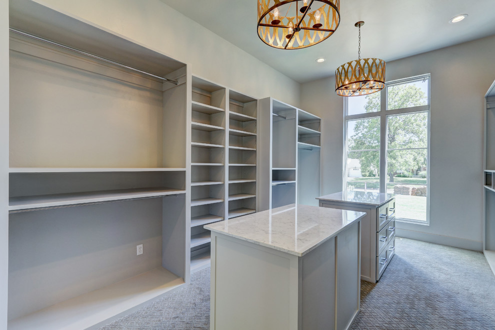 Walk-in closet - huge transitional gender-neutral carpeted walk-in closet idea in Oklahoma City with recessed-panel cabinets and white cabinets