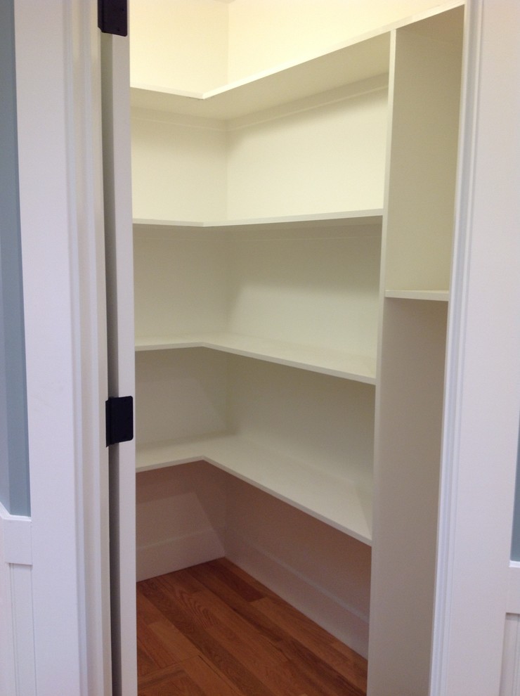 Inspiration for a mid-sized contemporary light wood floor and brown floor walk-in closet remodel in San Francisco with open cabinets and white cabinets