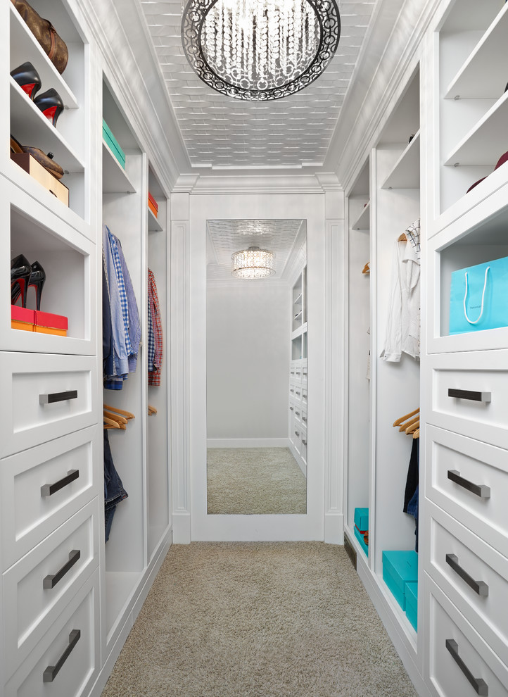 Traditional walk-in wardrobe in Edmonton with shaker cabinets, white cabinets and carpet.